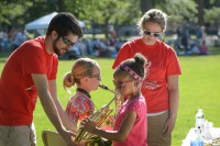 Music Education students assist children at the instrument petting zoo